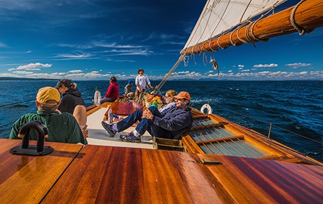 Guests relaxing on the Schooner Ladona by Martin McKenzie