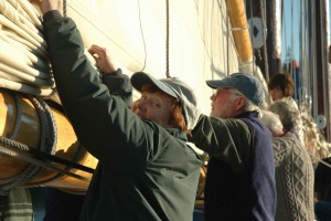 Guests help furl the sails aboard the Mary Day